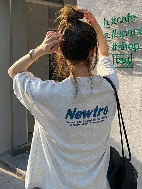 Oversized Harajuku streetwear tee featuring bold 'Newtro' graphic and relaxed fit, perfect for juniors.