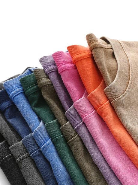 Collection of colorful cotton casual t-shirts stacked in various shades, showcasing diverse styles and hues.