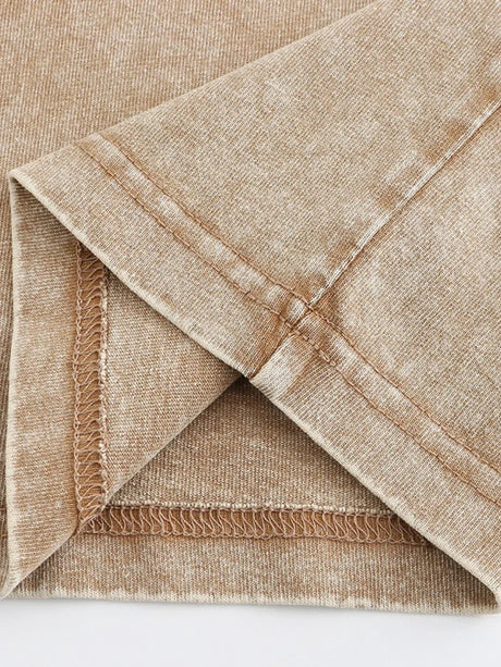 Close-up of the seam and fabric texture of a casual t-shirt in beige color, showcasing high-quality cotton material.