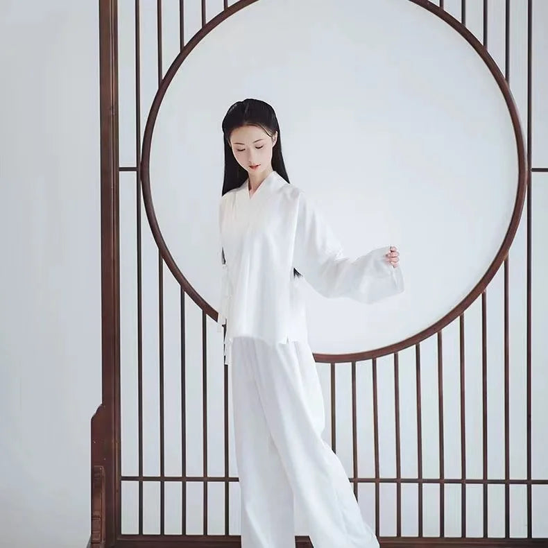Elegant woman wearing a white Ming Dynasty Hanfu inner robe, showcasing traditional Chinese fashion against a minimalist backdrop.