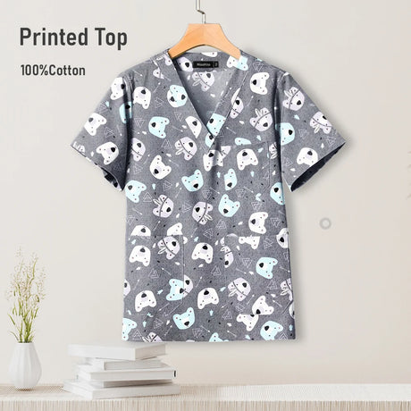 Gray cotton pediatric surgical scrub top with playful animal print, perfect for nursing uniforms.