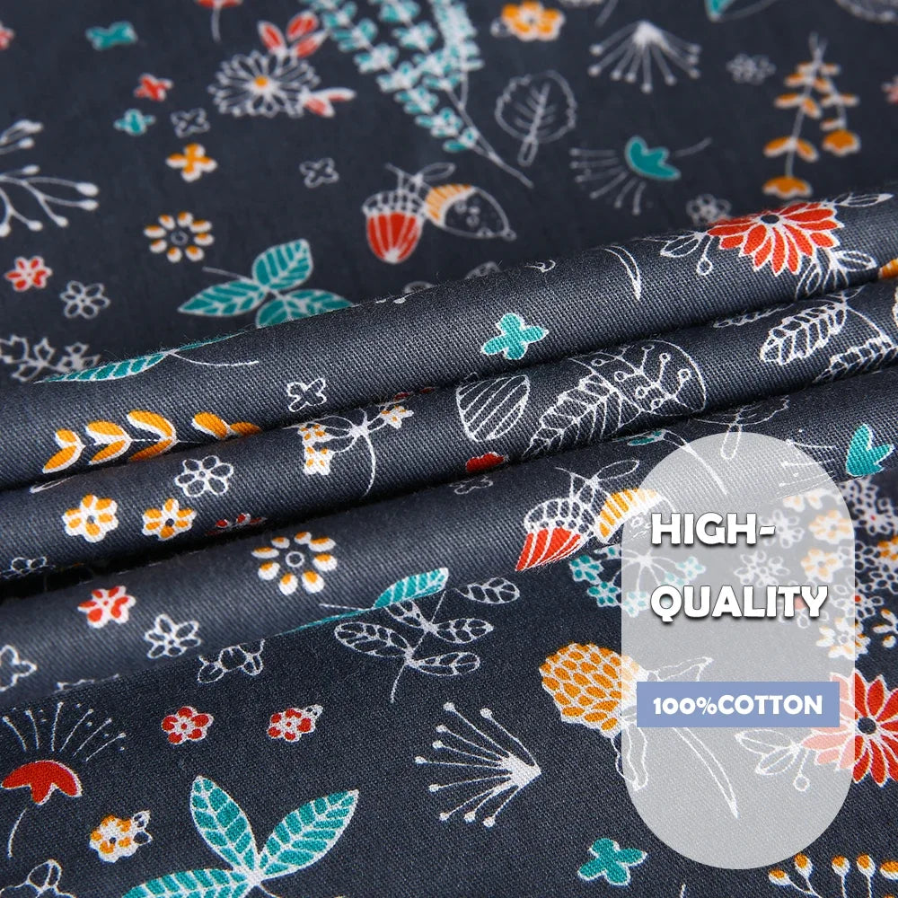 Close-up of high-quality 100% cotton fabric with colorful floral patterns on a dark background.