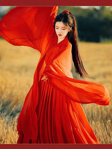 Woman in flowing wine red Swordsman Hanfu costume dancing in a field, showcasing Tang Dynasty style and elegance.