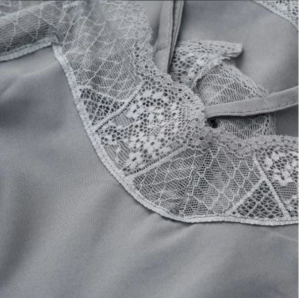Close-up of elegant satin fabric with intricate lace detail, showcasing the quality of the SatéBelle™ camisole.