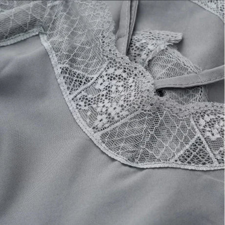 Close-up of elegant satin fabric with intricate lace detail, showcasing the quality of the SatéBelle™ camisole.