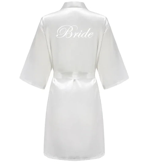 White satin bride robe with elegant script text on the back, perfect for bridal parties.