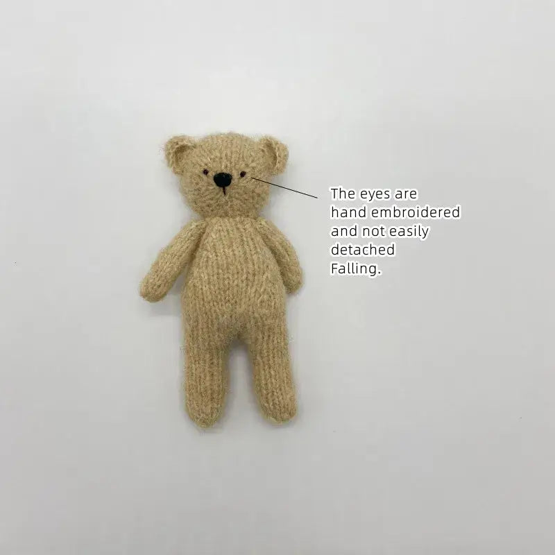 Handmade plush bear toy with embroidered eyes, perfect for newborn photography and safe for baby play.