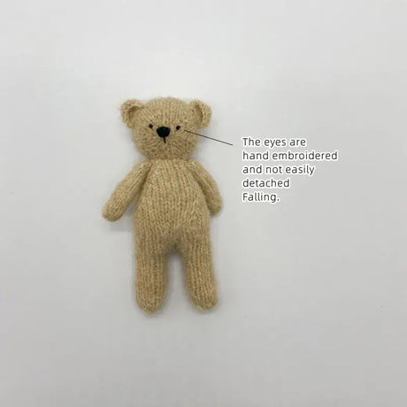 Handmade plush bear toy with embroidered eyes, perfect for newborn photography and safe for baby play.