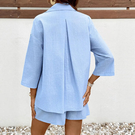 Back view of a woman wearing a light blue 2-piece casual maternity set, featuring a shirt and matching shorts.