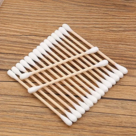 100pcs Baby Cotton Swabs in a bag, wooden sticks and soft cotton tips for babies, perfect for hygiene use.