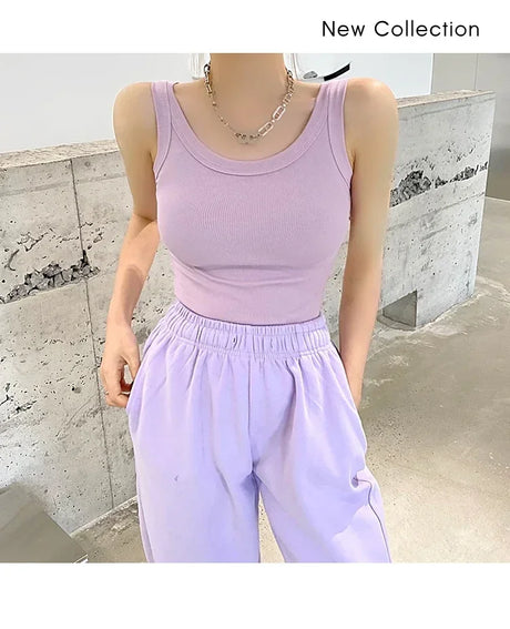 Model wearing a sleeveless light purple ribbed tank top from RetroRib™, paired with relaxed lavender pants.