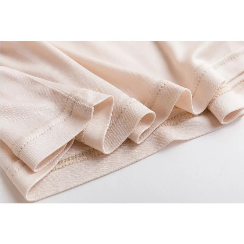 Close-up of SilkAura™ silk blend knit camisole's soft fabric and seamless edges, perfect for summer lingerie.