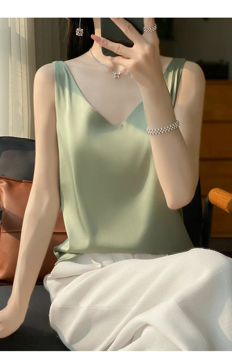 Model wearing a green satin V-neck camisole, showcasing summer style and comfort.