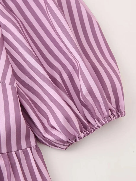 Close-up of the purple striped sleeve of the BowChic™ lace-up blouse, showcasing its elegant design and fabric texture.