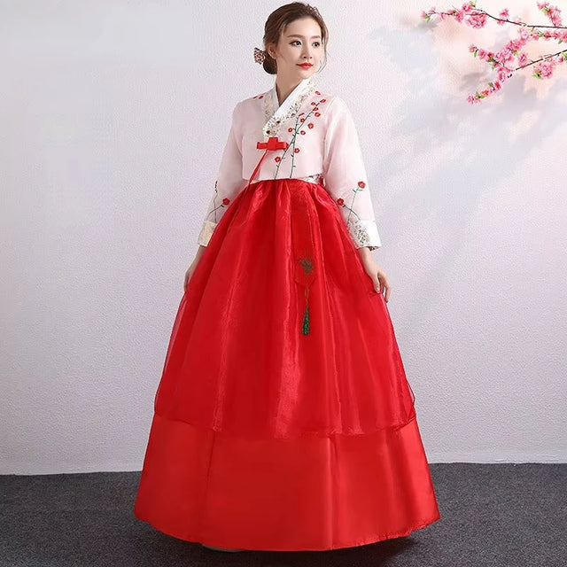 Traditional Korean Hanbok dress in red and white, perfect for cultural celebrations and performances.