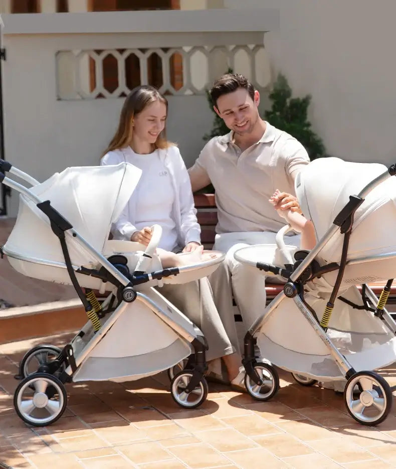 Parents enjoying time with their infants in a twin baby stroller in a sunny outdoor setting.