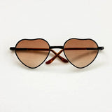 Heart-shaped baby sunglasses for newborn photography, perfect colorful accessory for gender-neutral photo shoots.