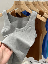 RibFlex™ Basic O-Neck Tank in gray displayed on hangers with assorted colors, featuring high elasticity and comfortable ribbed fabric.