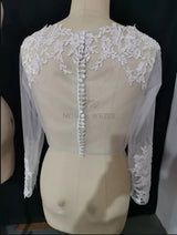 Lace bridal bolero jacket with long sleeves and appliques, showcasing intricate detailing and button closure at the back.