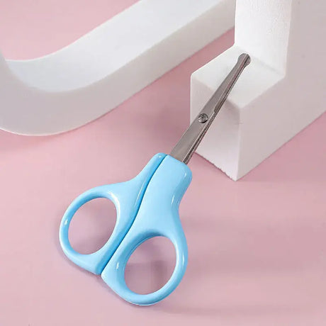 Light blue baby nail scissors designed for newborn care, ideal for trimming tiny nails safely.