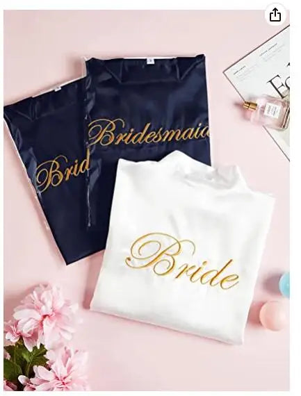 Bride and Bridesmaid satin robes in navy and white, perfect for bridal party attire and wedding preparation.