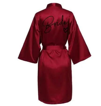 Back view of a satin burgundy robe featuring 'Bride' text, perfect for wedding festivities.