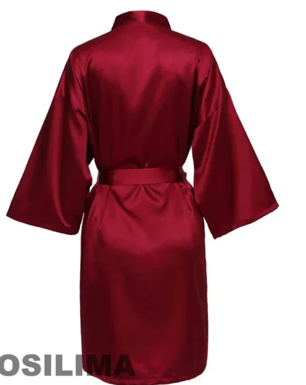 Back view of a burgundy satin robe with kimono sleeves and a tie belt, perfect for bridesmaids or lounging.