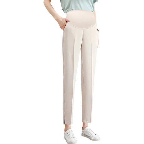 Stylish maternity pants in beige, featuring a comfortable waistband and pockets, ideal for summer work wear.