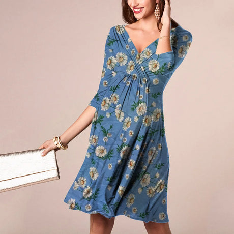 Woman in a blue floral dress, showcasing a V-neck design and knee-length silhouette, ideal for summer nursing wear.