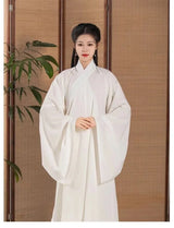 Elegant woman wearing a Ming Dynasty Hanfu inner robe costume in white, showcasing traditional Chinese fashion.