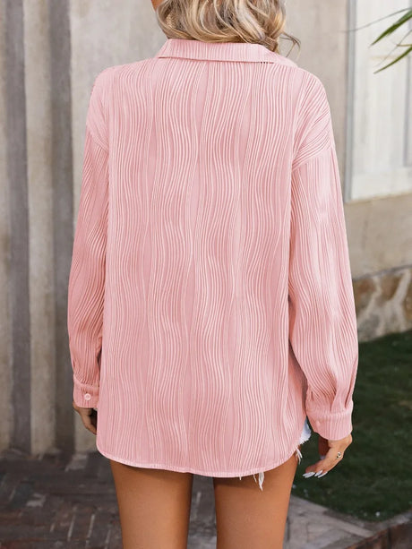 Back view of a loose-fitting pink casual blouse with a turn-down collar, featuring a textured design for women.