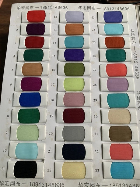 Swatch chart displaying various color options for tulle fabrics, showcasing vibrant hues and shades available for bridal wear.