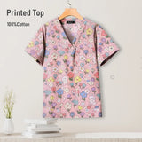 Colorful printed cotton scrub top featuring a floral design, suitable for pediatric nursing uniforms.