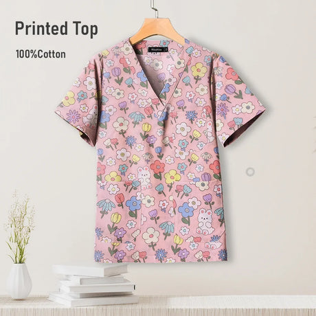 Colorful printed cotton scrub top featuring a floral design, suitable for pediatric nursing uniforms.