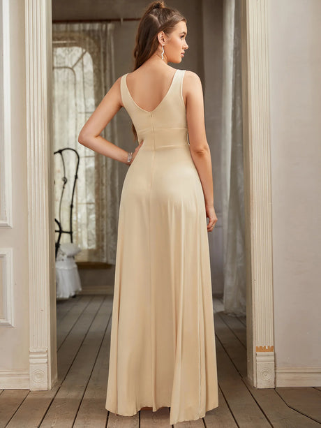 Elegant back view of a floor-length V-neck bridesmaid evening dress in light beige, showcasing a sleek satin silhouette.