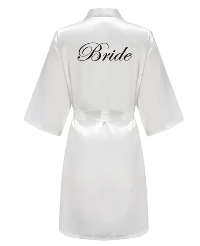 White satin robe with 'Bride' text on the back, perfect for bridal parties and wedding preparations.