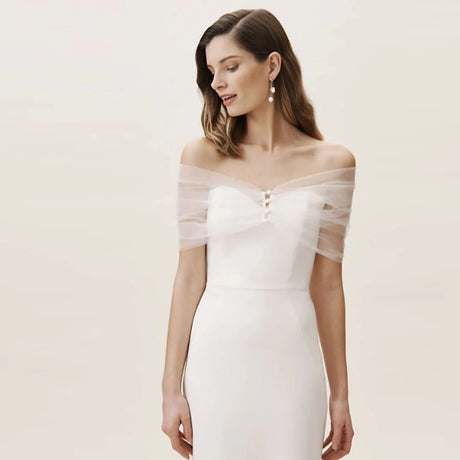 Model wearing the VG73 sheer wedding jacket, an elegant short see-through bolero, enhancing a bridal gown.