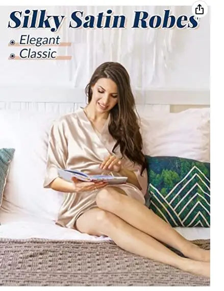Elegant woman in a silky satin robe, showcasing classic sleepwear style in a cozy setting.