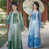 Two women in traditional Hanfu cosplay dresses, one in a green ensemble holding a parasol, the other in blue.