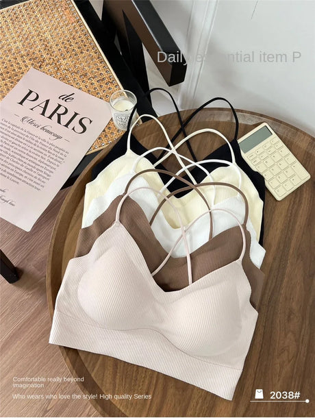 Collection of soft padded tank tops in various colors on a wooden table, perfect for summer wear.