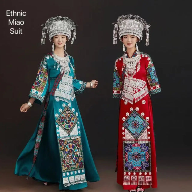 Two women in vibrant Miao embroidery suits showcasing traditional ethnic costumes.