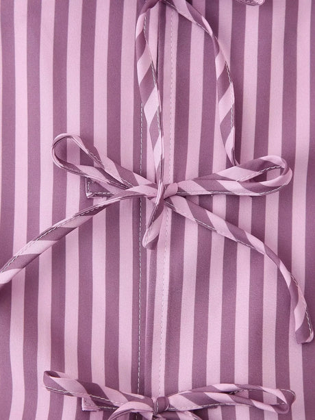 Close-up of BowChic™ Stripe Lace-Up Blouse featuring pink and purple stripes with a lace-up detail.