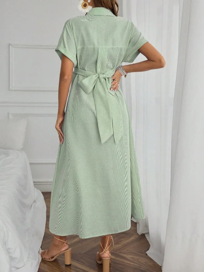 Back view of a striped short sleeve maternity dress in mint green, featuring a tie waist and mid-calf length for comfort.