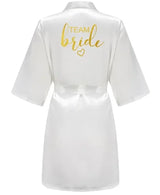 White satin kimono robe with 'TEAM BRIDE' in gold lettering, perfect for bridal parties.