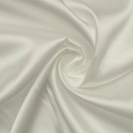 Close-up of elegant white satin fabric, smooth and lustrous, ideal for luxury clothing and bridal accessories.