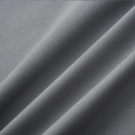 Close-up of elegant gray satin fabric showcasing smooth texture and subtle sheen, ideal for clothing like camisoles.