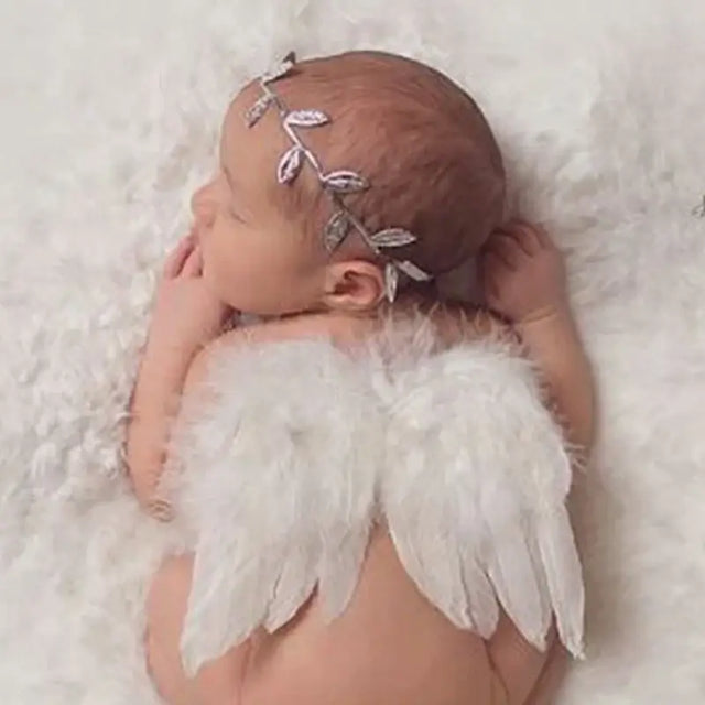 Newborn girl with angel wing costume and headband, perfect for baby photography props and outfits.