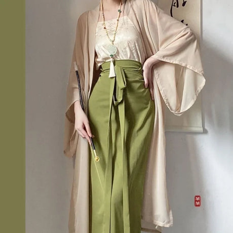 Elegant woman wearing a beige Princess Song Dynasty Hanfu layered over an olive green skirt, showcasing traditional Chinese fashion.