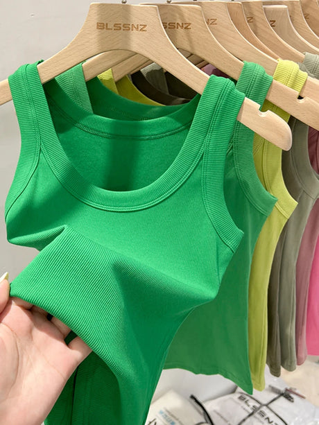 Green ribbed tank top displayed with additional colors hanging behind, showcasing summer style and elastic comfort.