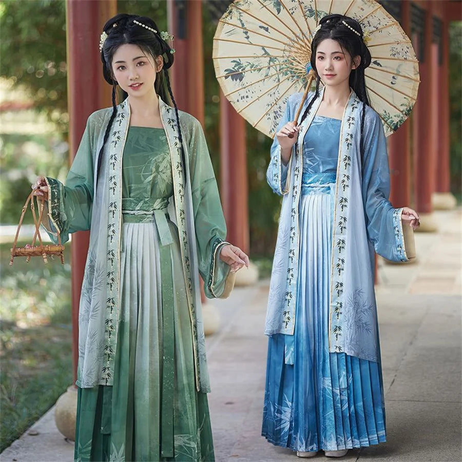 Women in traditional Hanfu cosplay dresses, featuring a green dress and a blue dress, with delicate parasol and scenic background.